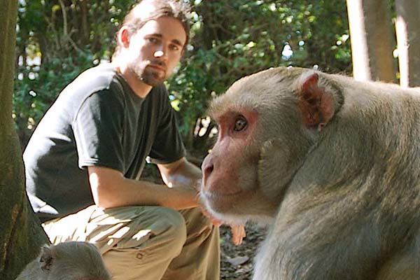 Professor Justin Wood with a monkey