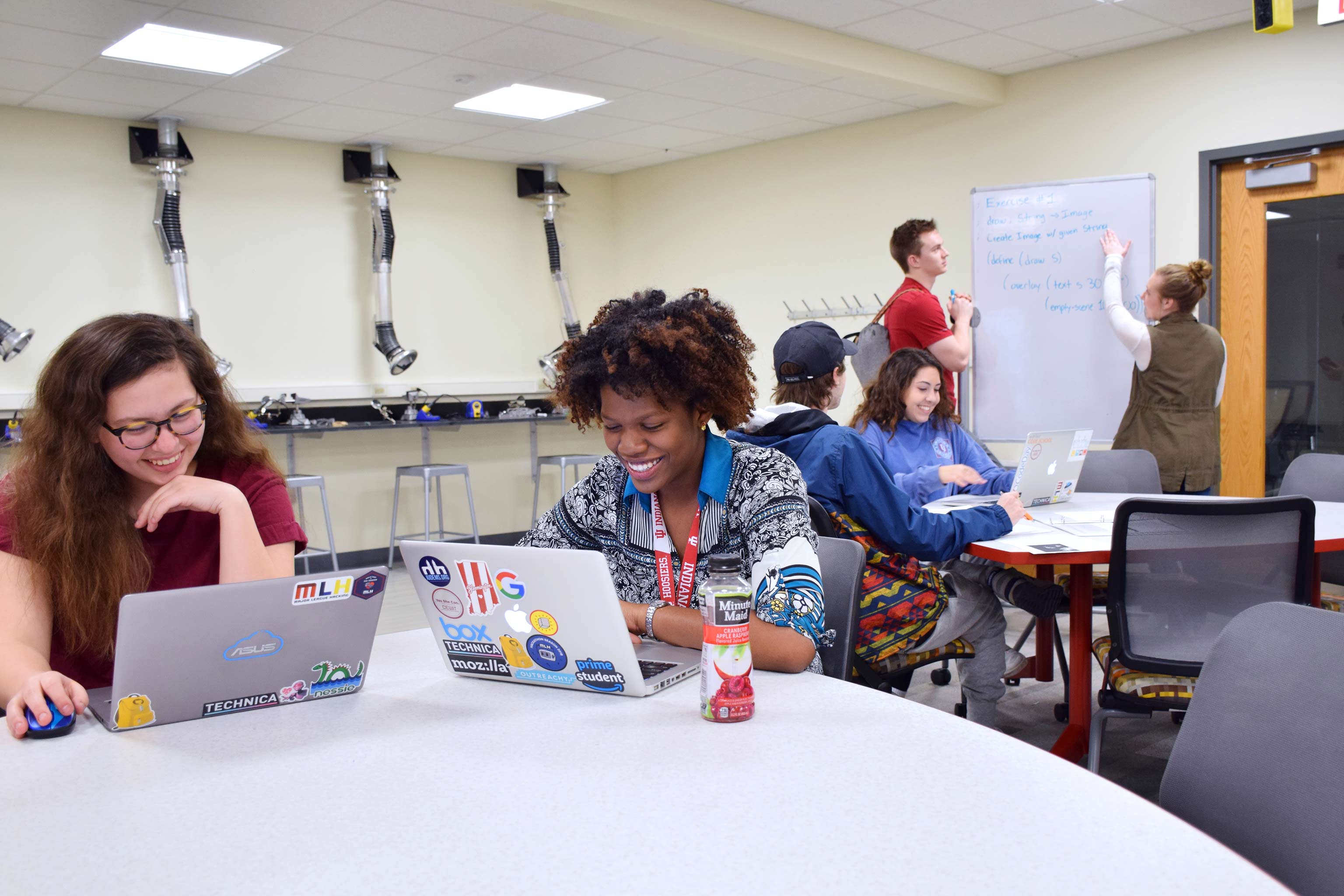 Students study in groups in a lab common space.